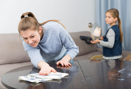 Mother and daughter cleans the house