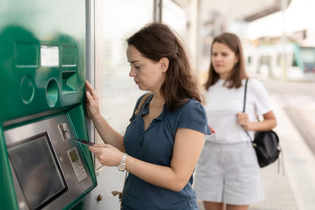 Brunette buying ticket for public transport