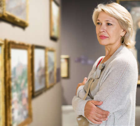 Woman looking at picture collectionの写真素材