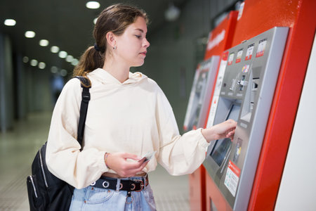 Woman buying a ticket to the subway train