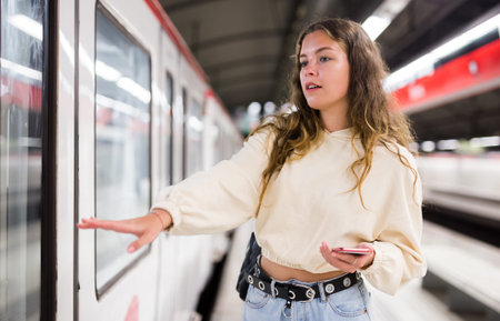 Portrait of a girl in the subway, about to enter the train carの写真素材