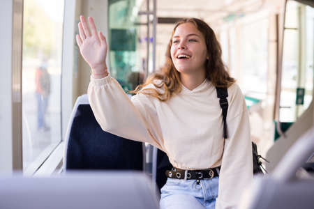 Portrait of a positive girl riding on public transportの写真素材