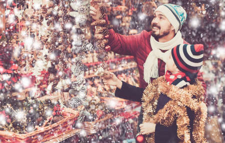 Little girl with dad buying decorations for Xmasの写真素材