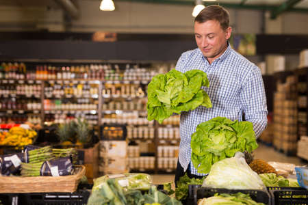 Man buying greens for saladの写真素材