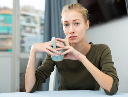 Young unhappy woman tired of problems having headache indoors