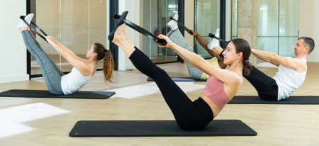 People exercising with pilates ring at classの写真素材