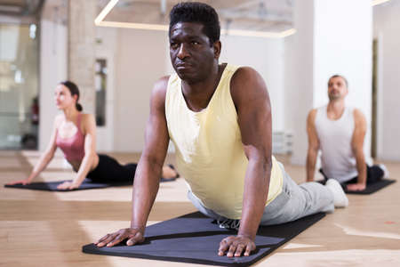 Man practicing pilates exercises at group classの写真素材