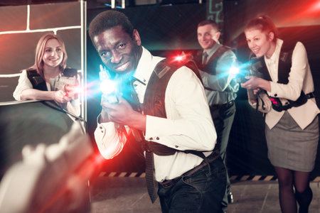 Nice Afro man and colleagues in laser tag room