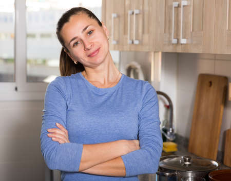 Portrait of happy woman in kitchenの写真素材
