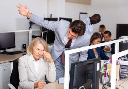 Boss blaming adult female office workerの写真素材
