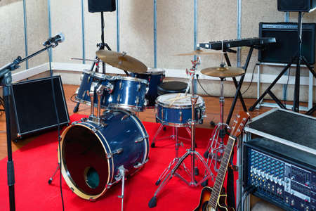 Modern music instruments and equipments for rock band in empty rehearsal roomの写真素材
