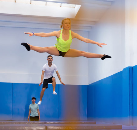 People training in trampoline center