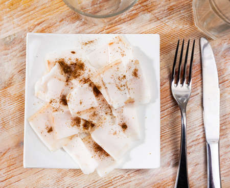 Delicious lard on a plate, cut into piecesの写真素材