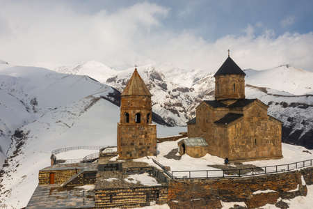 Medieval Gergeti Trinity Church at foot of Mount Kazbegi, Georgiaの写真素材