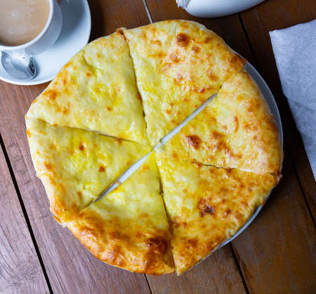 Traditional Megrelian khachapuri with sulguni cheese added on topの写真素材