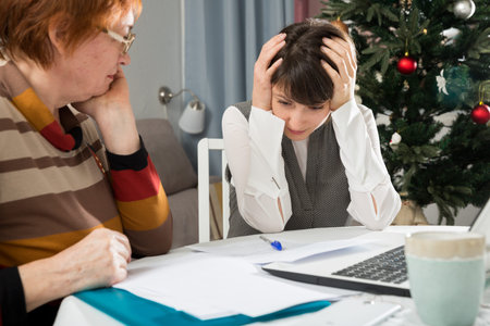 Upset woman and her mother with papers