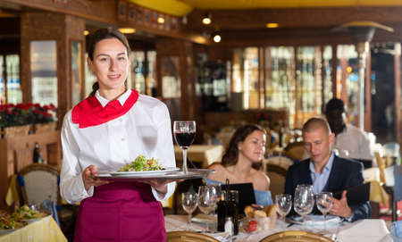 Portrait of waitress ready to serving mealsの写真素材