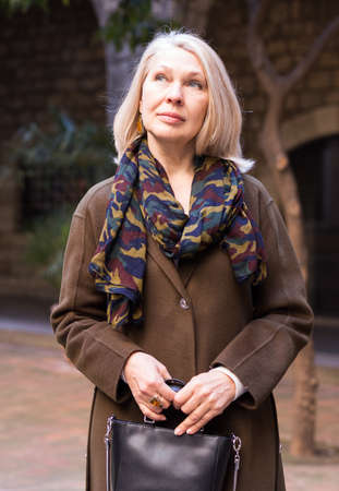 Portrait of positive woman sightseeing in european cityの写真素材