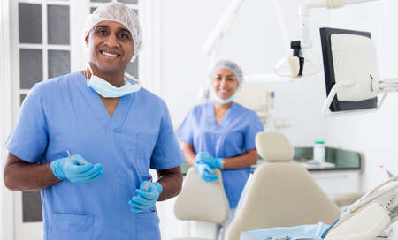 Successful professional dentist standing in modern dental officeの写真素材