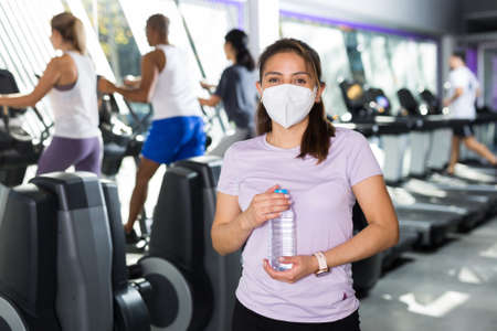 Woman resting after workout with still waterの写真素材