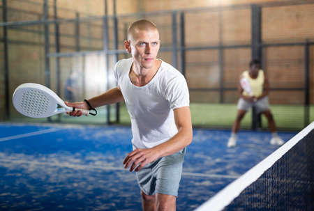 Man playing padel tennis on padel courtの写真素材