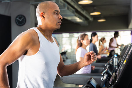 Man training on treadmill at fitness center