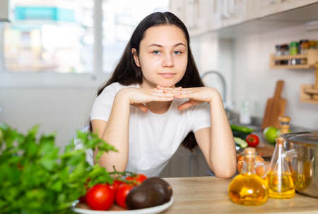 Portrait of young woman posing in kitchenの写真素材
