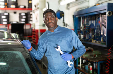 Portrait of african male mechanician posing in workshopの写真素材