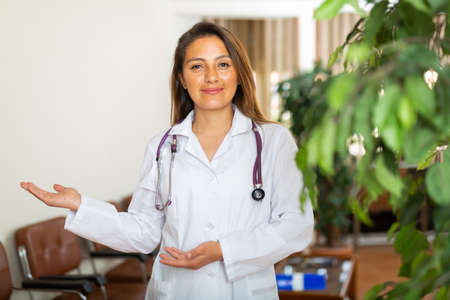Confident woman doctor standing in officeの写真素材