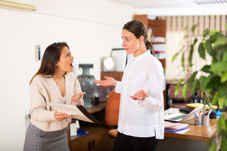 Irritated woman boss scolding manager for incompetenceの写真素材