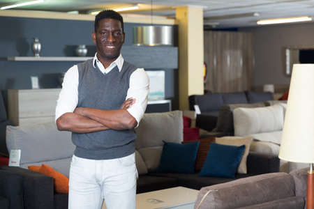 Assistant male is standing near modern furnitureの写真素材