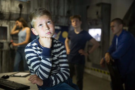 Portrait of a pensive boy with his family in quest room