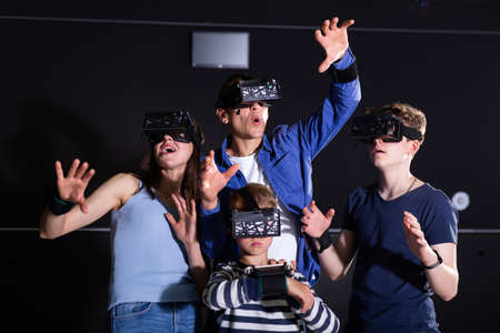 Cheerful family in vr goggles playing games togetherの写真素材