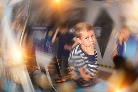 Pensive preteen boy solving riddles in quest roomの写真素材