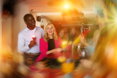 Man bartender shaking cocktail mixer for young people