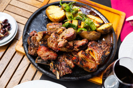 Image of the popular Spanish dish Chuleton of beef steak with bone, served delicious potatoes and...