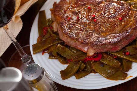 Beef entrecote with string beans and bell pepperの写真素材