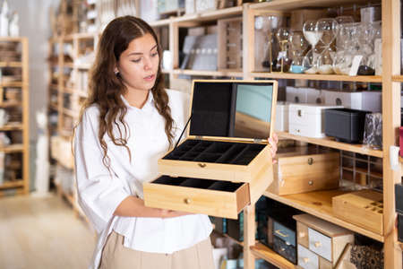 Woman choosing jewelry storage box at shopの写真素材