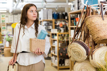 Woman buyer standing in shopping room with decor for homeの写真素材