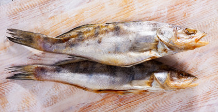 Jerked pikeperch on a wooden table