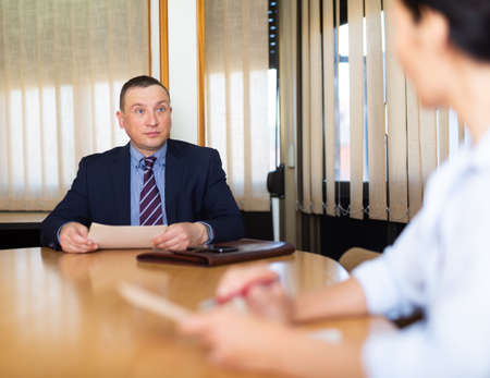 Businessman discussing partnership documents with female partnerの写真素材