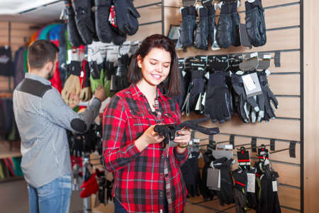 Girl with a man choose new protective glovesの写真素材