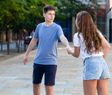 Portrait of girl and boy teenagers walking outdoorsの写真素材