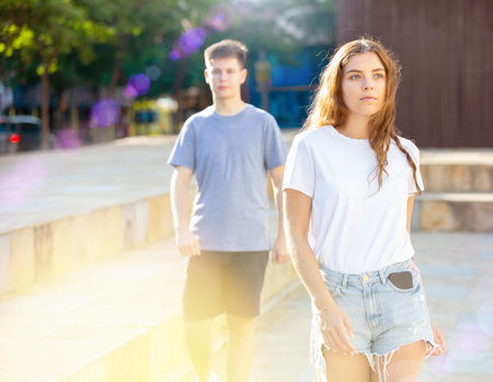 Positive young teen girl walks down street