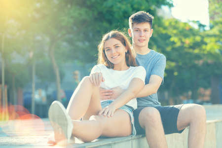 Young man is hugging his girlfriendの写真素材