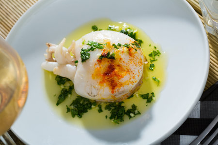 Sepia served with green sauce from garlic and olive oil, served with parsley