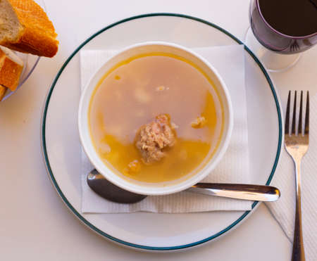 Soup with pasta, meatballs, potato slices and chickpeasの写真素材