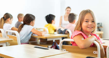 Schoolgirl sitting in classroomの写真素材