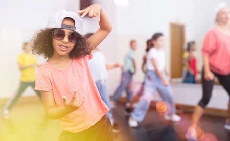 Confident preteen african american girl breakdancer in dance studioの写真素材