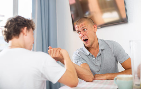 Father and son competing in arm wrestling
